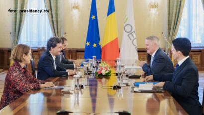 România cama aproapea di OCDE